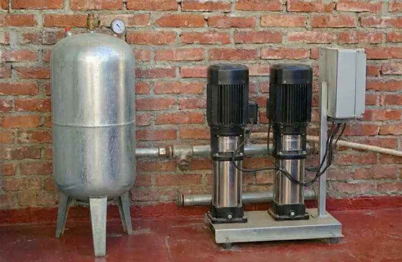 How to increase water pressure in your home with professional booster pump system installation showing pump unit, pressure tank, and gauge